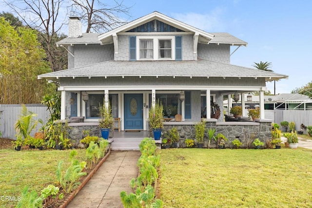 view of front of home with a front yard and covered porch