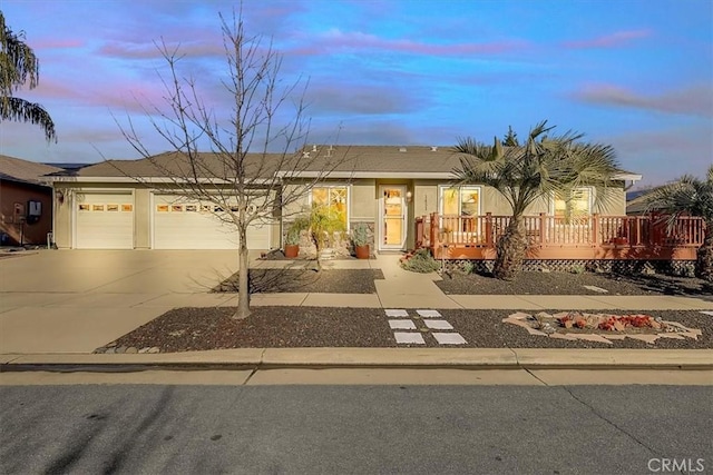 view of front of property featuring a wooden deck and a garage