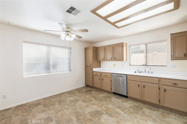 kitchen featuring light countertops, visible vents, stainless steel dishwasher, a sink, and baseboards