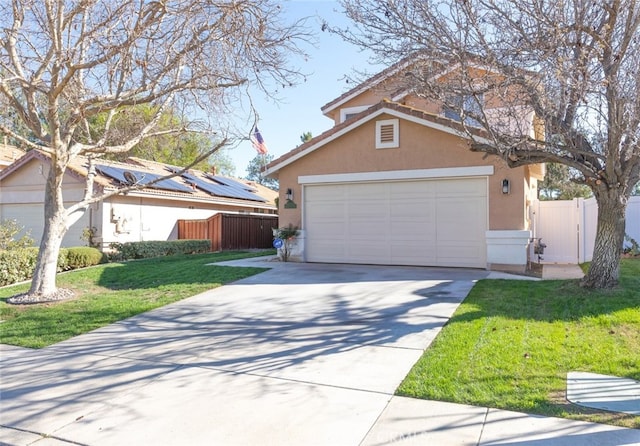 view of front facade with driveway, fence, a front lawn, and stucco siding