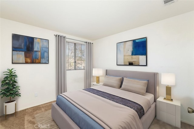 carpeted bedroom featuring visible vents