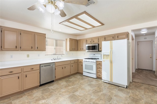 kitchen with visible vents, ceiling fan, appliances with stainless steel finishes, light countertops, and a sink