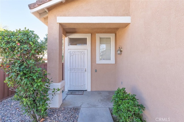 property entrance with stucco siding