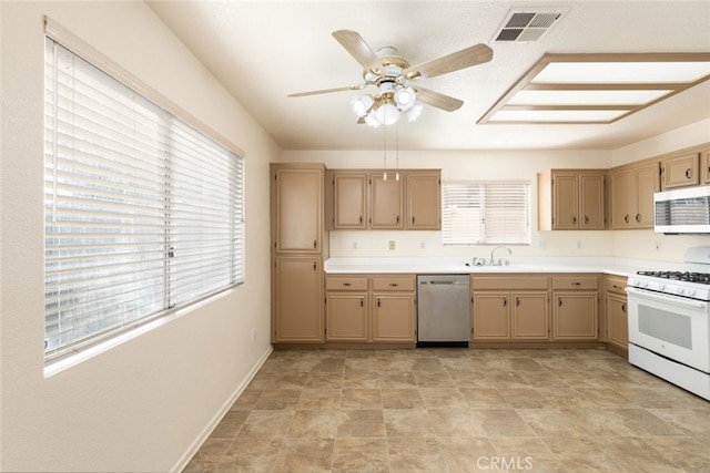 kitchen with visible vents, ceiling fan, appliances with stainless steel finishes, light countertops, and a sink