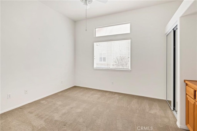 interior space with light colored carpet and a closet