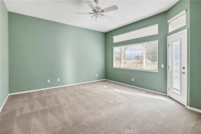 carpeted spare room with ceiling fan