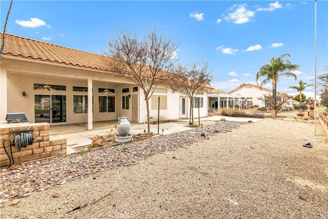 back of house with a patio and ceiling fan