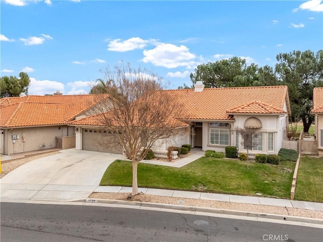 mediterranean / spanish-style home with a garage and a front lawn