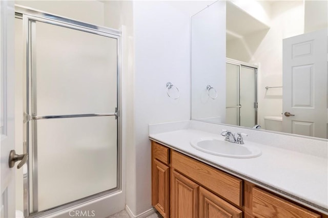 bathroom with vanity, an enclosed shower, and toilet