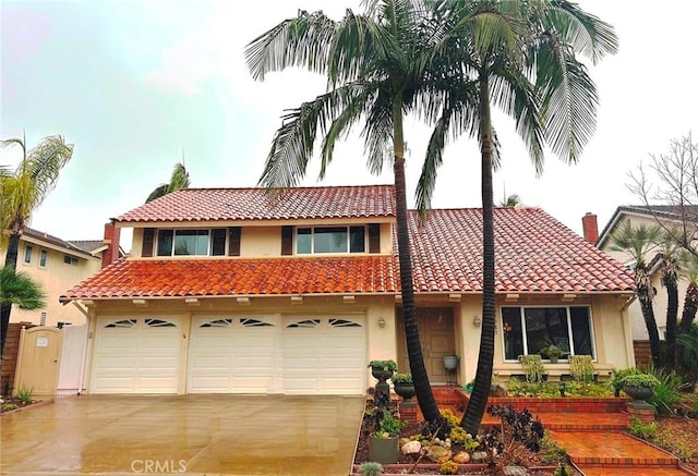 mediterranean / spanish-style home featuring a garage