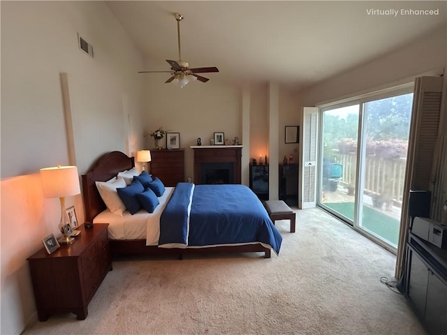 bedroom with lofted ceiling, access to outside, and light carpet