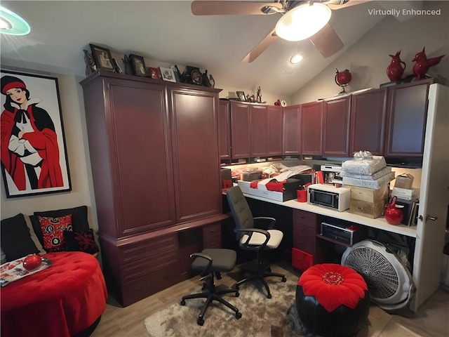 office featuring ceiling fan, vaulted ceiling, and light hardwood / wood-style flooring