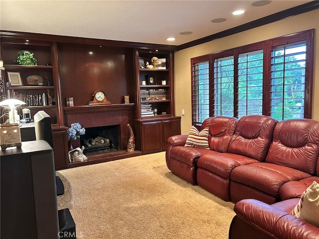 carpeted living room with crown molding, a fireplace, and built in features