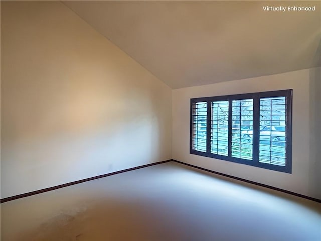 unfurnished room featuring vaulted ceiling