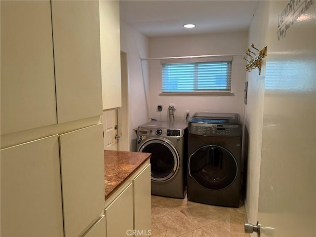 washroom with light tile patterned flooring, cabinets, and separate washer and dryer