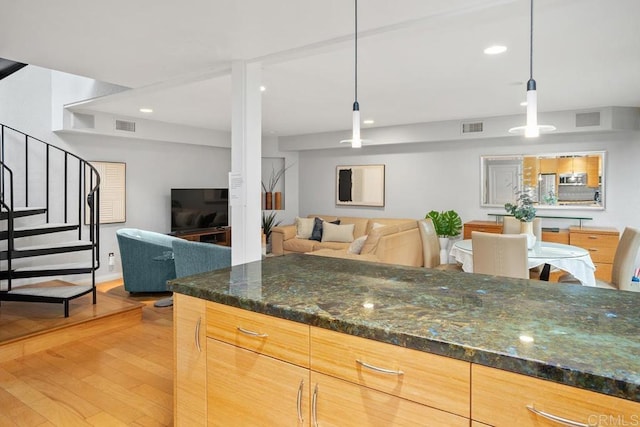 675 S Sierra Ave Unit 15, Solana Beach, CA 92075 - kitchen featuring light wood-style floors, open floor plan, hanging light fixtures, dark stone countertops, and recessed lighting