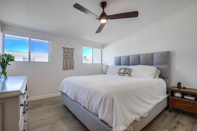 bedroom with ceiling fan and light hardwood / wood-style flooring