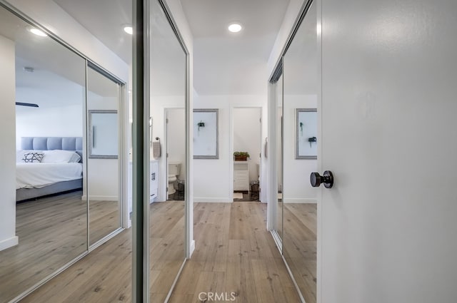 hallway with light hardwood / wood-style flooring