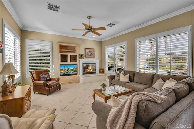 tiled living room featuring crown molding and ceiling fan