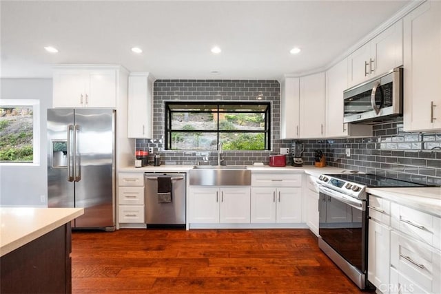 kitchen featuring white cabinets, stainless steel appliances, dark hardwood / wood-style flooring, and sink