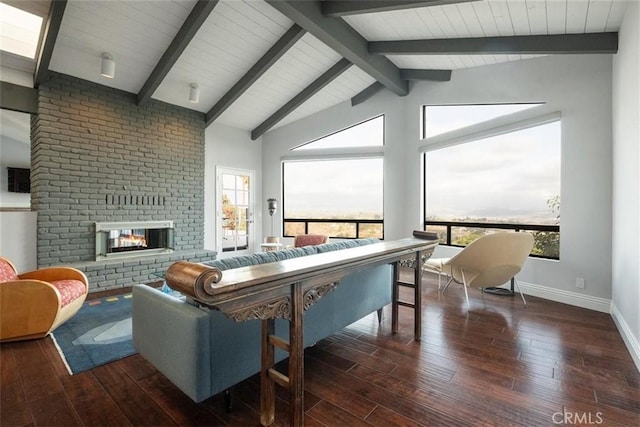 living room featuring dark hardwood / wood-style flooring, lofted ceiling with beams, and a fireplace