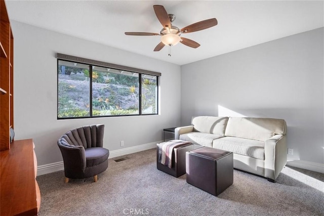 living area with ceiling fan and carpet floors