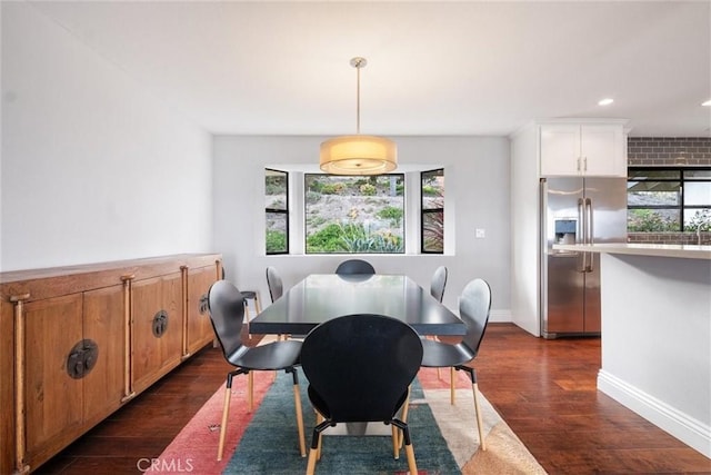 dining space with dark hardwood / wood-style flooring