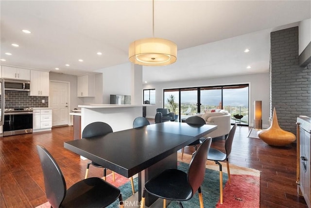 dining room with dark hardwood / wood-style flooring