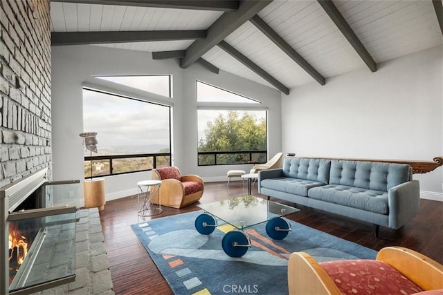 living room with a fireplace, lofted ceiling with beams, and dark wood-type flooring