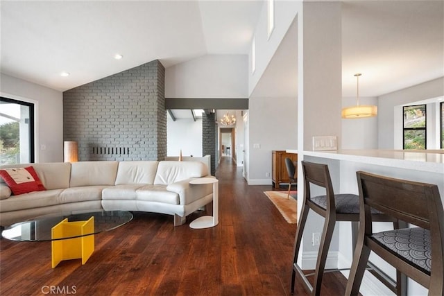 living room with dark hardwood / wood-style flooring and lofted ceiling