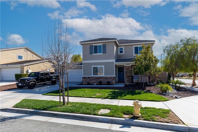 view of front of home with driveway, a front lawn, and stucco siding