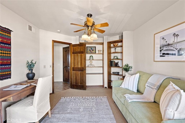 carpeted living area featuring ceiling fan and visible vents