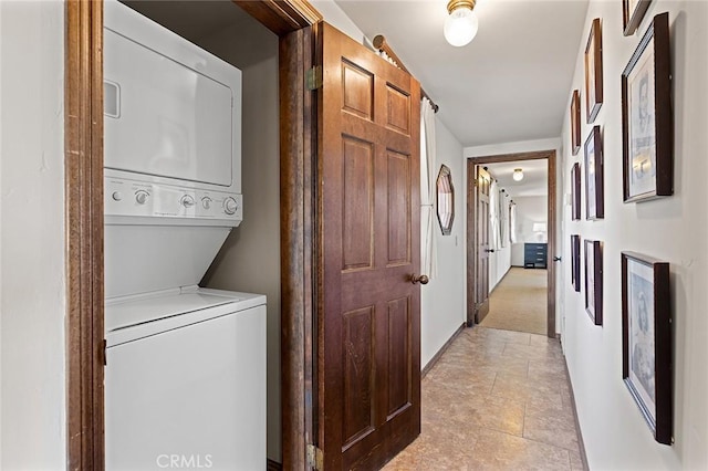 laundry room featuring stacked washer and dryer and laundry area