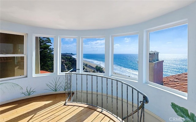 sunroom with a beach view and a water view