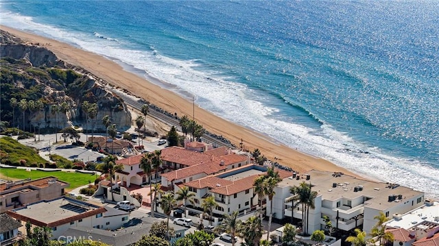 bird's eye view featuring a view of the beach, a water view, and a residential view