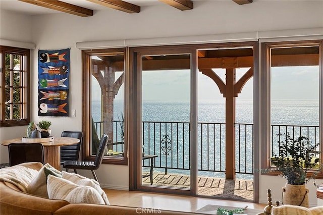 entryway with beamed ceiling and a water view