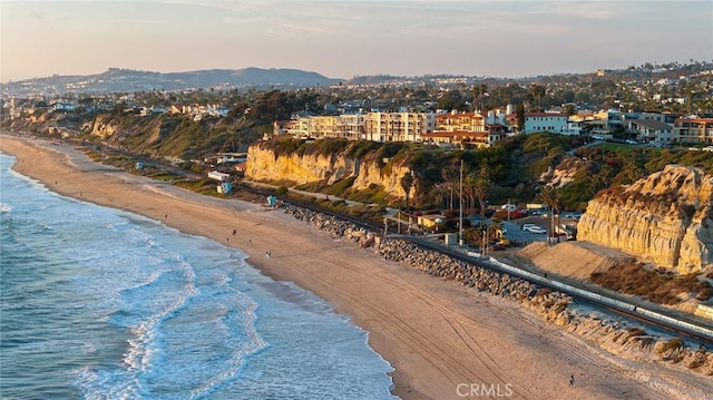 birds eye view of property featuring a water view and a view of the beach