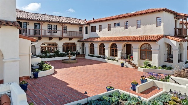 back of property featuring a patio and stucco siding