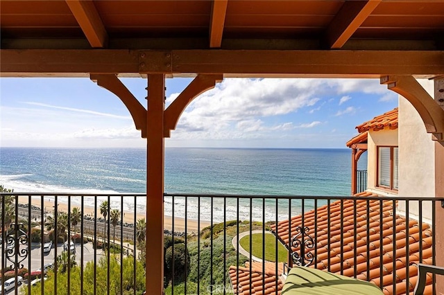 balcony featuring a water view and a view of the beach