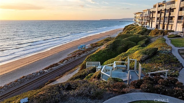 birds eye view of property with a beach view and a water view