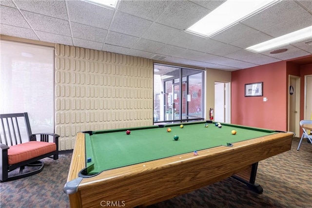 recreation room featuring a drop ceiling, dark carpet, and billiards