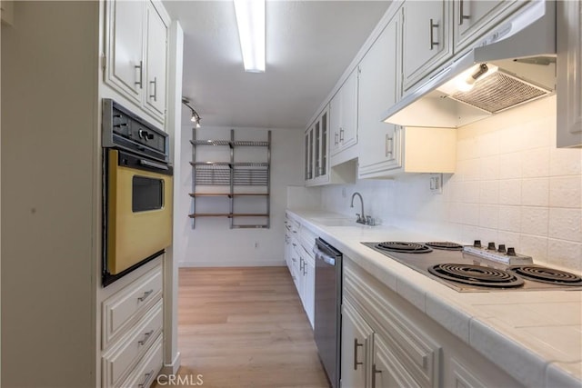 kitchen featuring sink, white cabinetry, tasteful backsplash, black electric cooktop, and wall oven