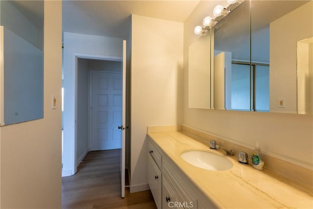 bathroom featuring vanity and hardwood / wood-style floors