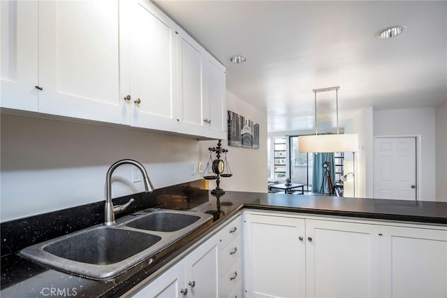 2525 E 19th St Unit 12, Signal Hill, CA 90755 - kitchen with dark countertops, white cabinets, pendant lighting, and a sink