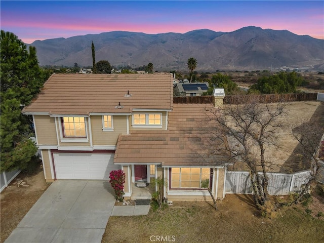 view of front of house featuring a garage and a mountain view