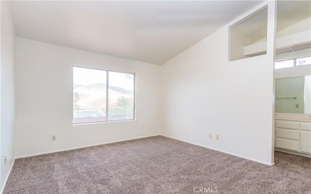 carpeted spare room with baseboards