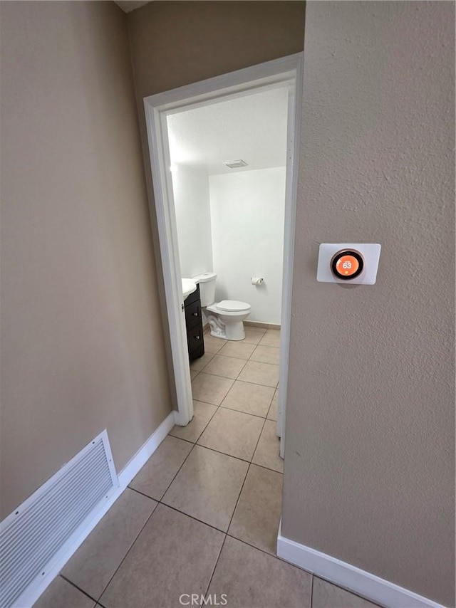 corridor with light tile patterned flooring