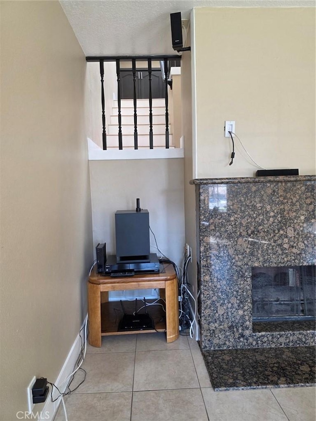 misc room featuring tile patterned flooring and a textured ceiling