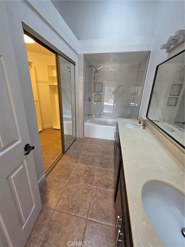 bathroom with vanity, tile patterned flooring, and tiled shower / bath