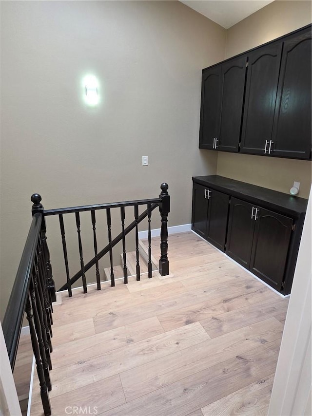 stairway with hardwood / wood-style floors